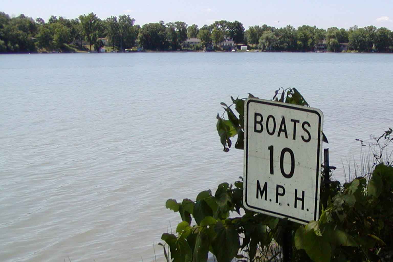 Sign by water reads "Boats 10 mph"